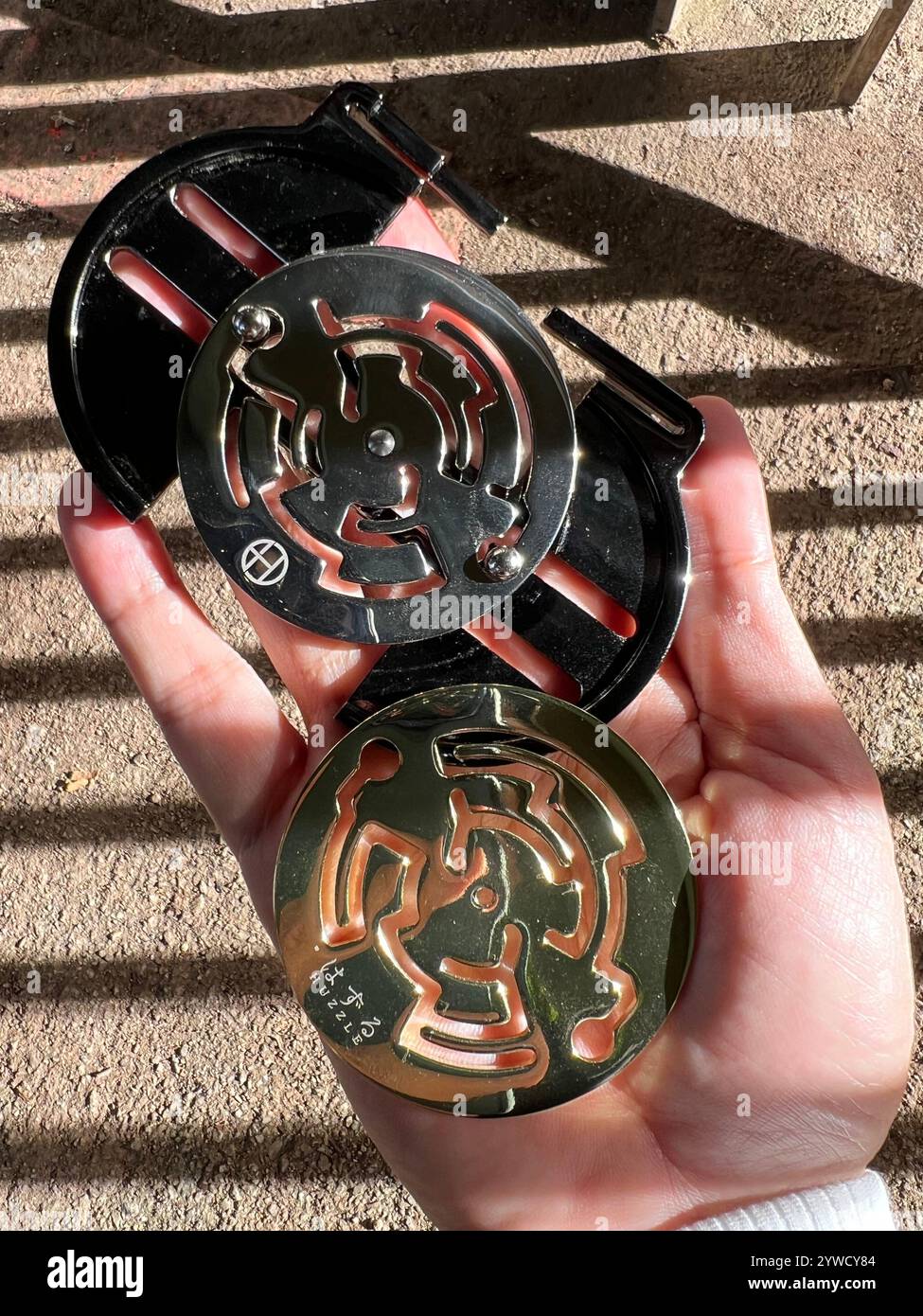 Huzzle puzzle game, purpose is to disassemble assemble the units. Made of cast metal alloy, high quality product, entertain to kill time. - Smartphone Captured Stock Image