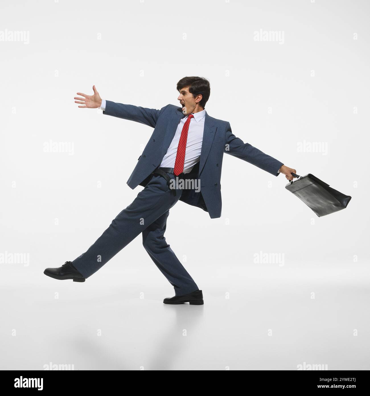 Cheerful businessman in blue suit and red tie posing energetically ...