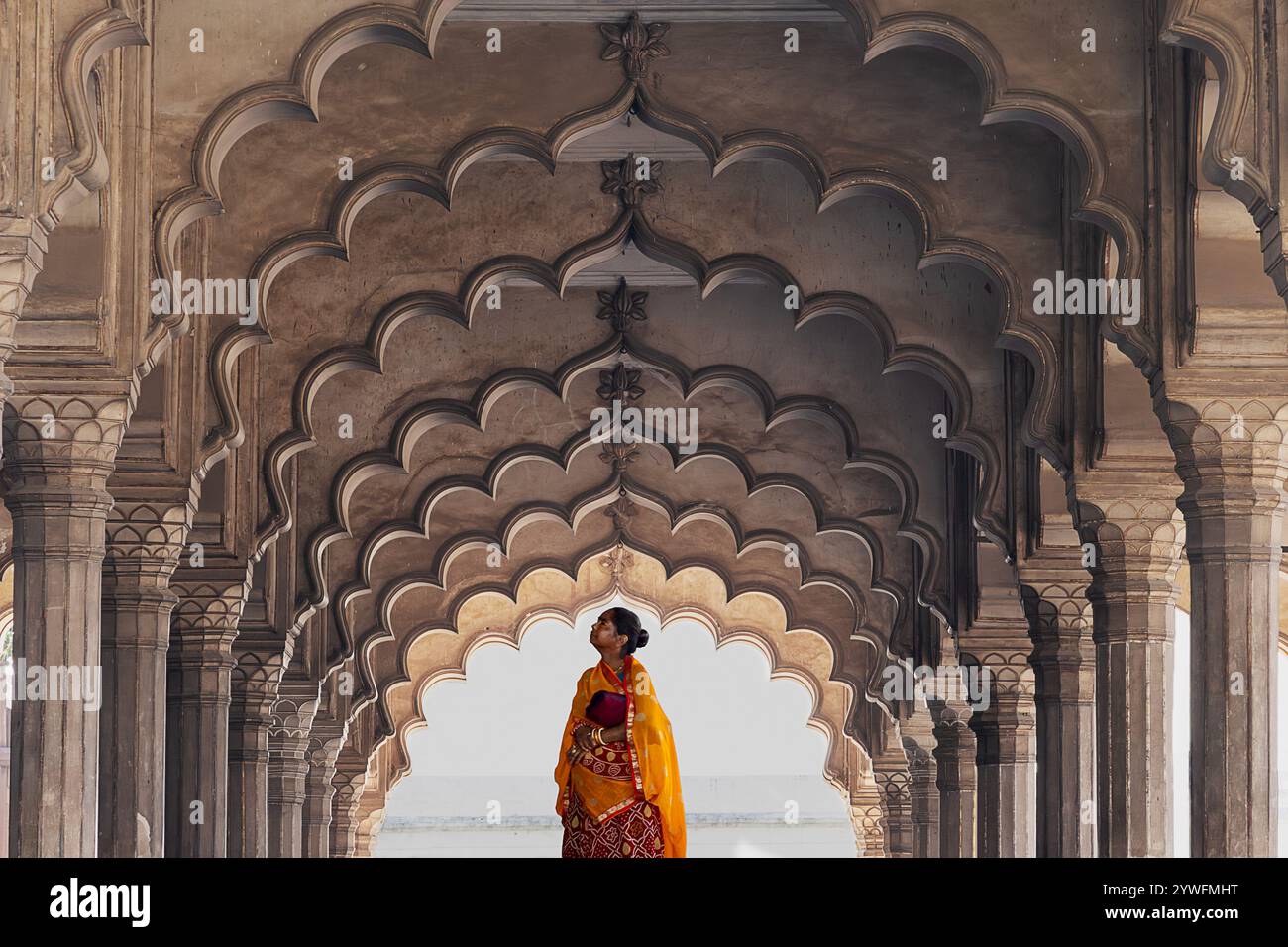 Local woman in traditional saree under the arcade in the Agra Fort in Agra, India Stock Photo