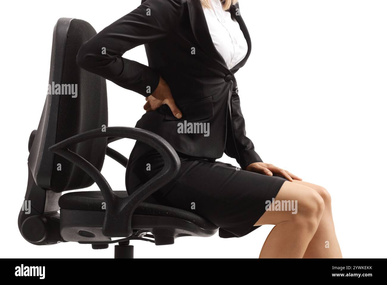Young woman with a painful lower back sitting in an office chair ...