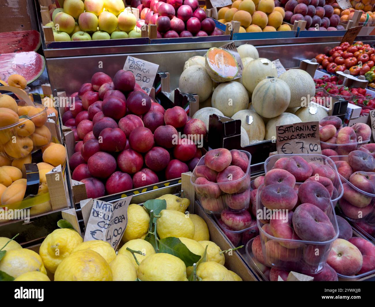 A variety of fresh fruits and vegetables are displayed, for sale in market produce bins in Europe. - Smartphone Captured Stock Image