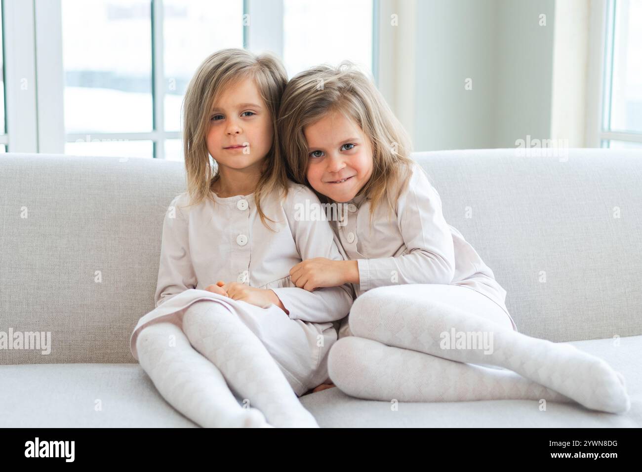 happy-family-sisterly-love-two-funny-little-twin-sisters-girls-hugging