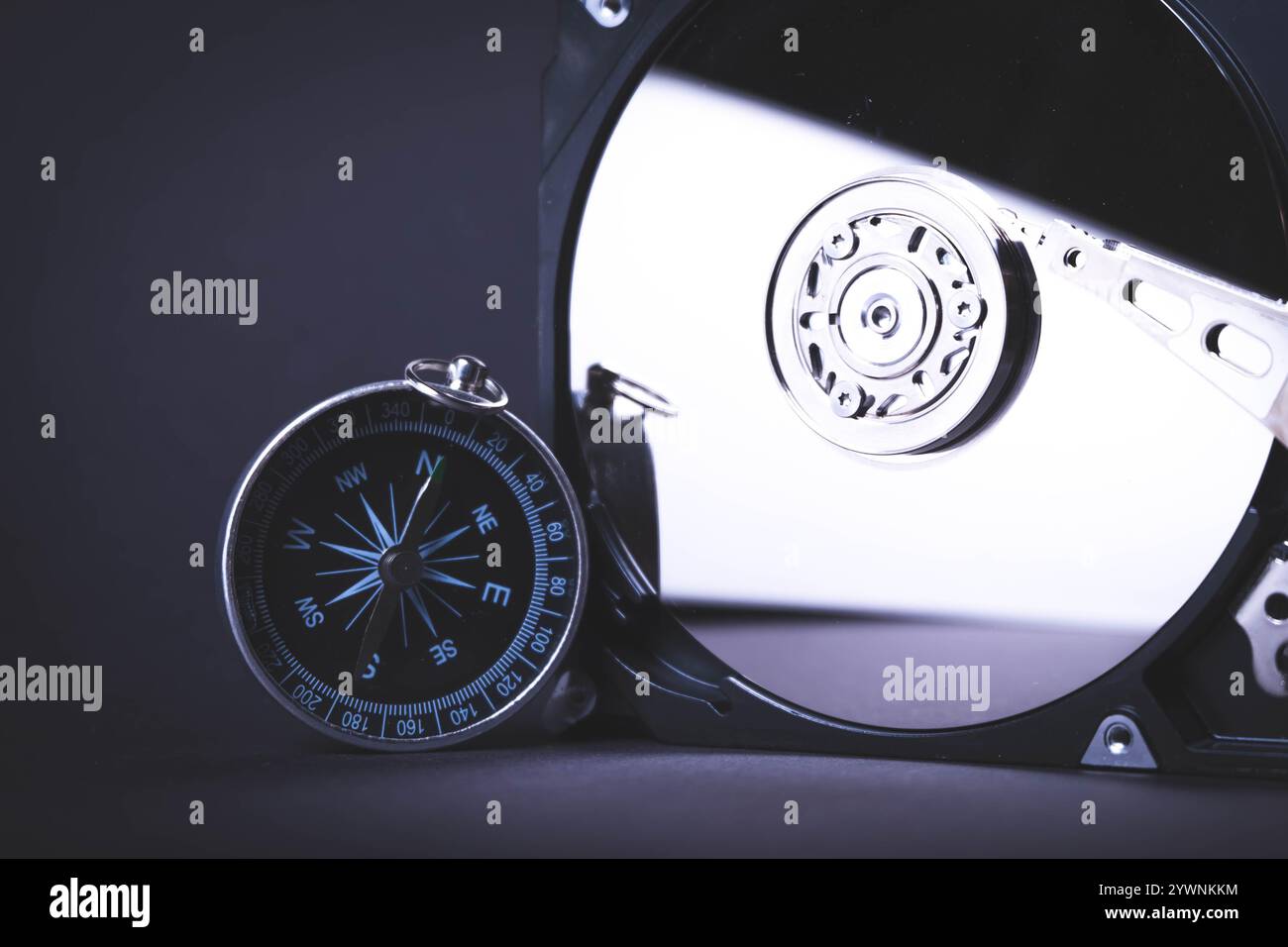 Searching for information on HDD. Compass and computer hard drive. Search for cryptocurrency. Bitcoin mining.. Stock Photo