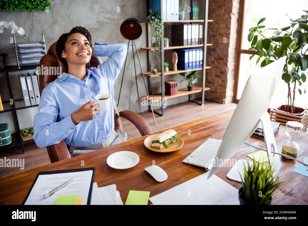 Successful businesswoman enjoying a coffee break in modern office ...