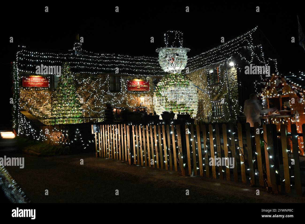 UK Christmas Lights. The Queen Victoria at Priddy in Somerset run by Mark Walton and wife Debs surrounds its entrance  and surounding area with over 55,000 illumination of lights making up a Snowman of glass bottle's and raising money for South West Children's Hospice. Picture Credit Robert Timoney/Alamy/LiveNews. Stock Photo