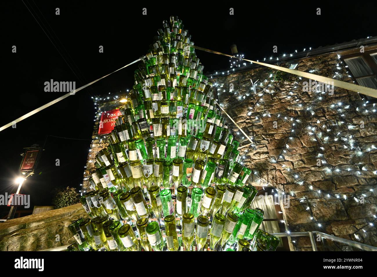 UK Christmas Lights. The Queen Victoria at Priddy in Somerset run by Mark Walton and wife Debs surrounds its entrance  and surounding area with over 55,000 illumination of lights making up a Snowman of glass bottle's and raising money for South West Children's Hospice. Picture Credit Robert Timoney/Alamy/LiveNews. Stock Photo