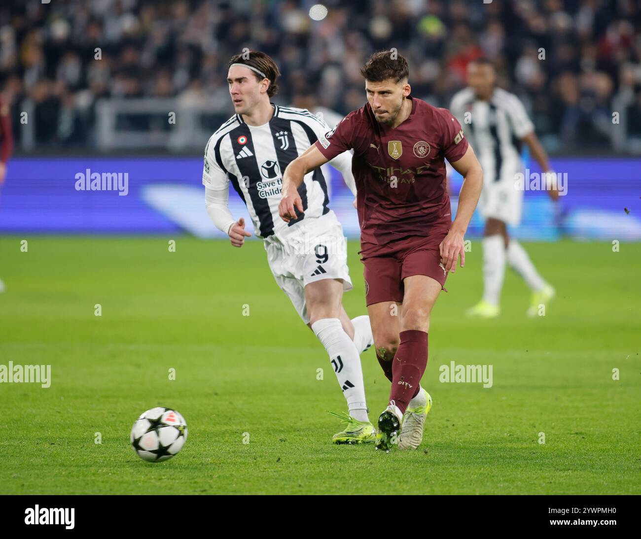 Turin, Italy. 11th Dec, 2024. Ruben Dias of Manchester City and Dusan Vlahovic of Juventus FC during the Uefa Champions League 2024/25, football match between Juventus FC and Manchester City, on 11 December 2024, at Allianz Stadium Turin Italy. Credit: Nderim Kaceli/Alamy Live News Stock Photo