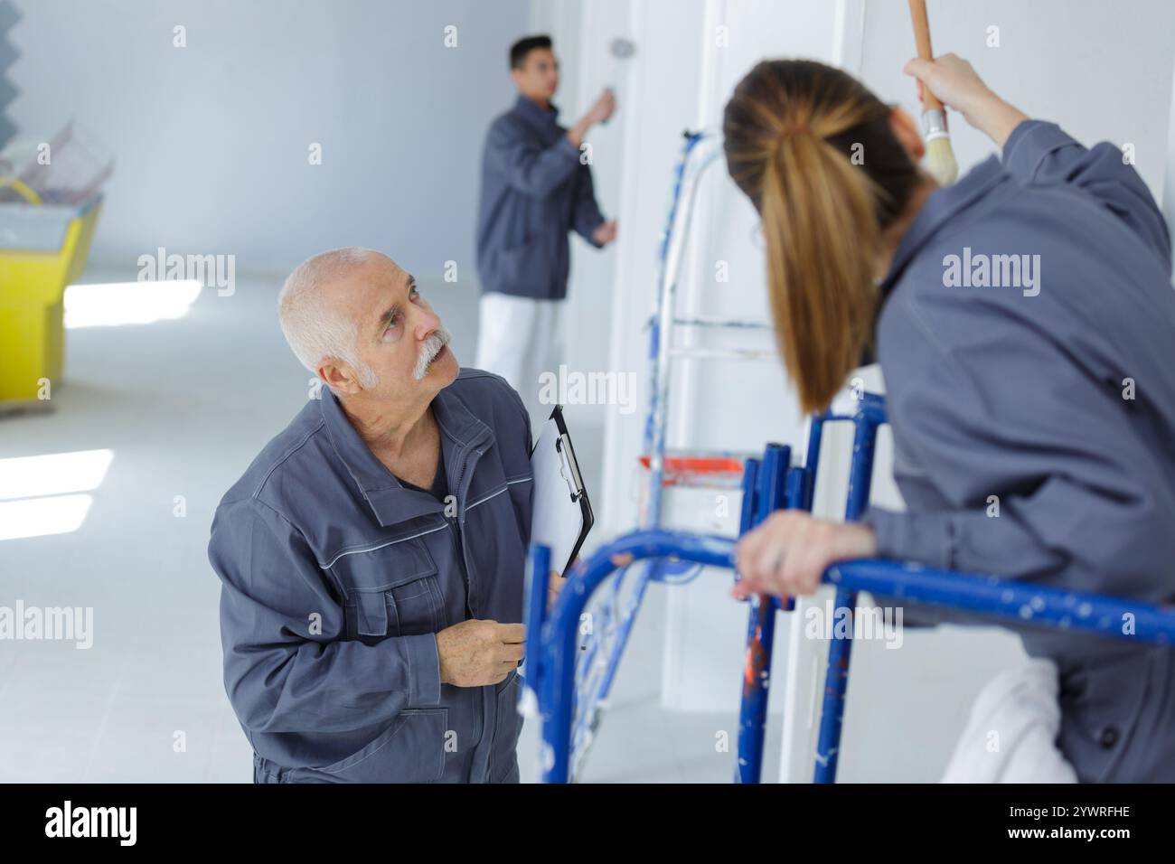 painter with apprentice and client Stock Photo
