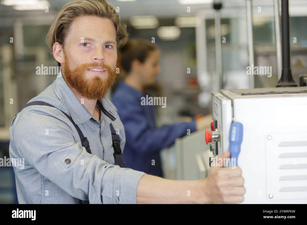 man assembles electronic components on a machine Stock Photo