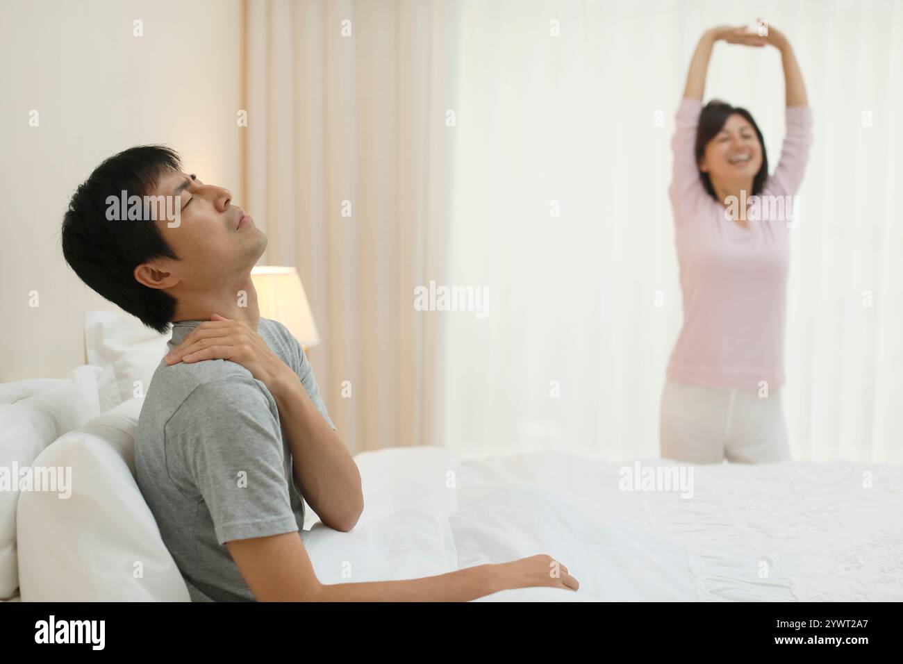 Husband in poor health and healthy wife Stock Photo