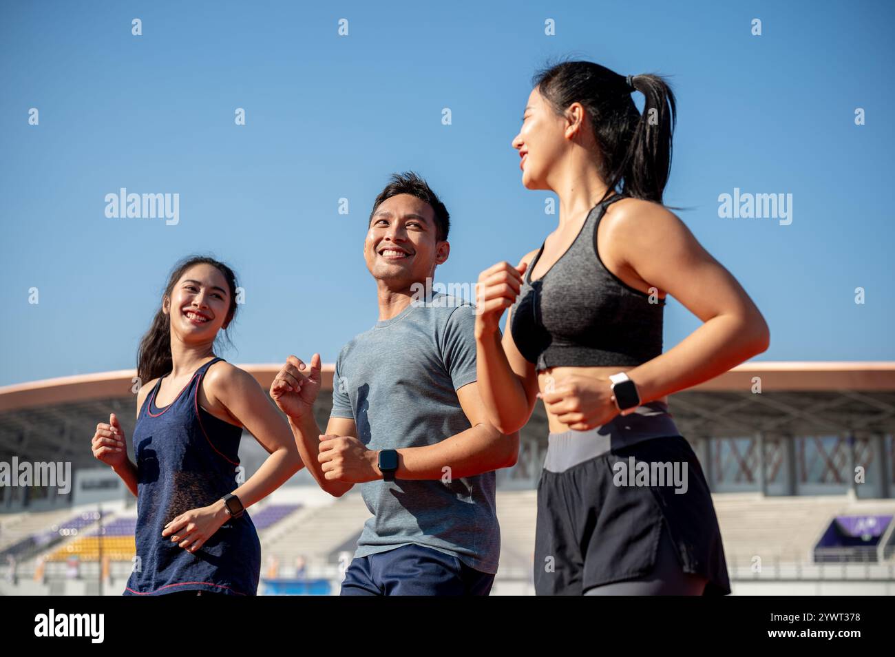 A group of cheerful Asian athlete runners enjoy a conversation while ...
