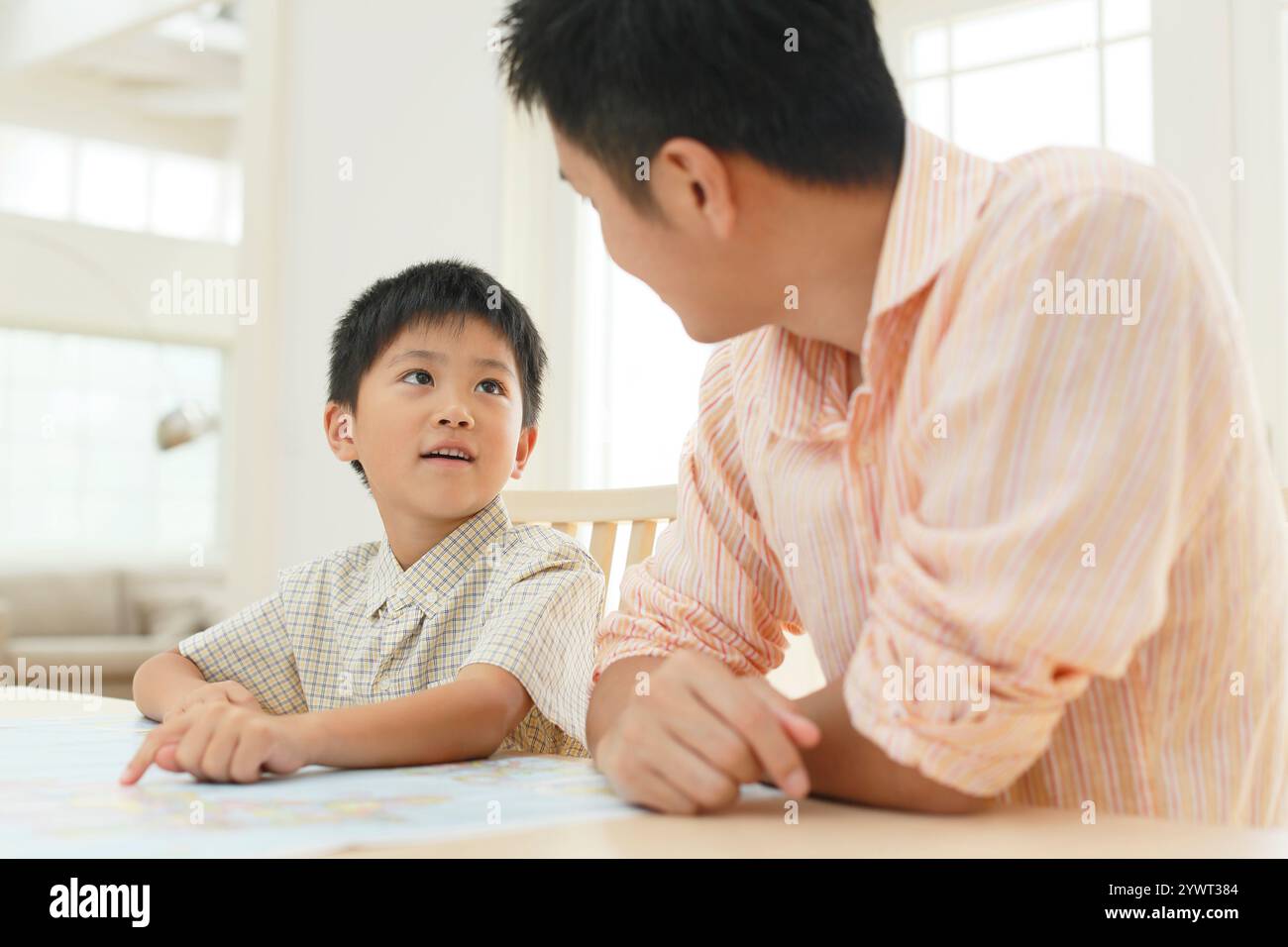 Father and child spreading map at table Stock Photo