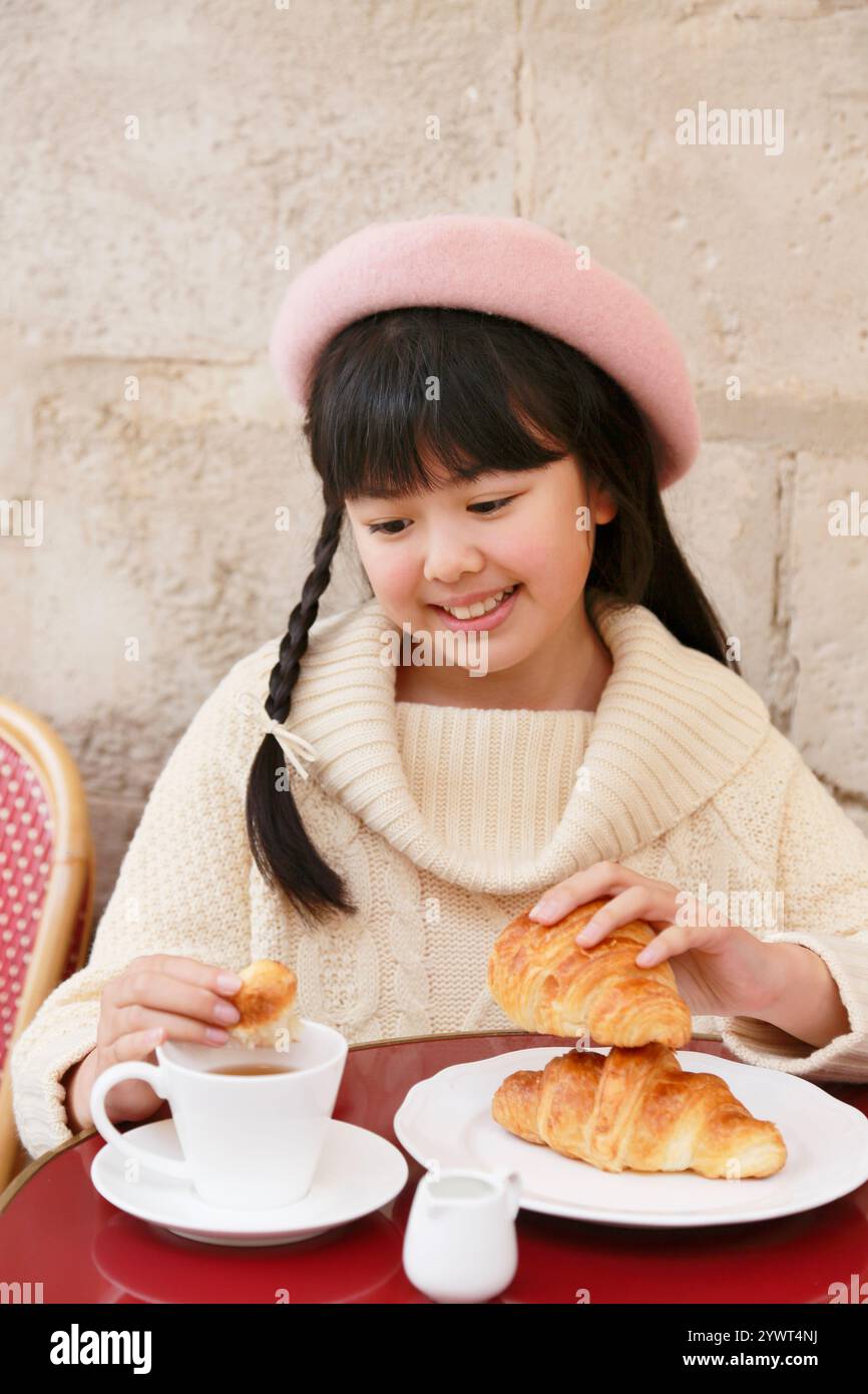 Girl having tea at a café Stock Photo - Alamy