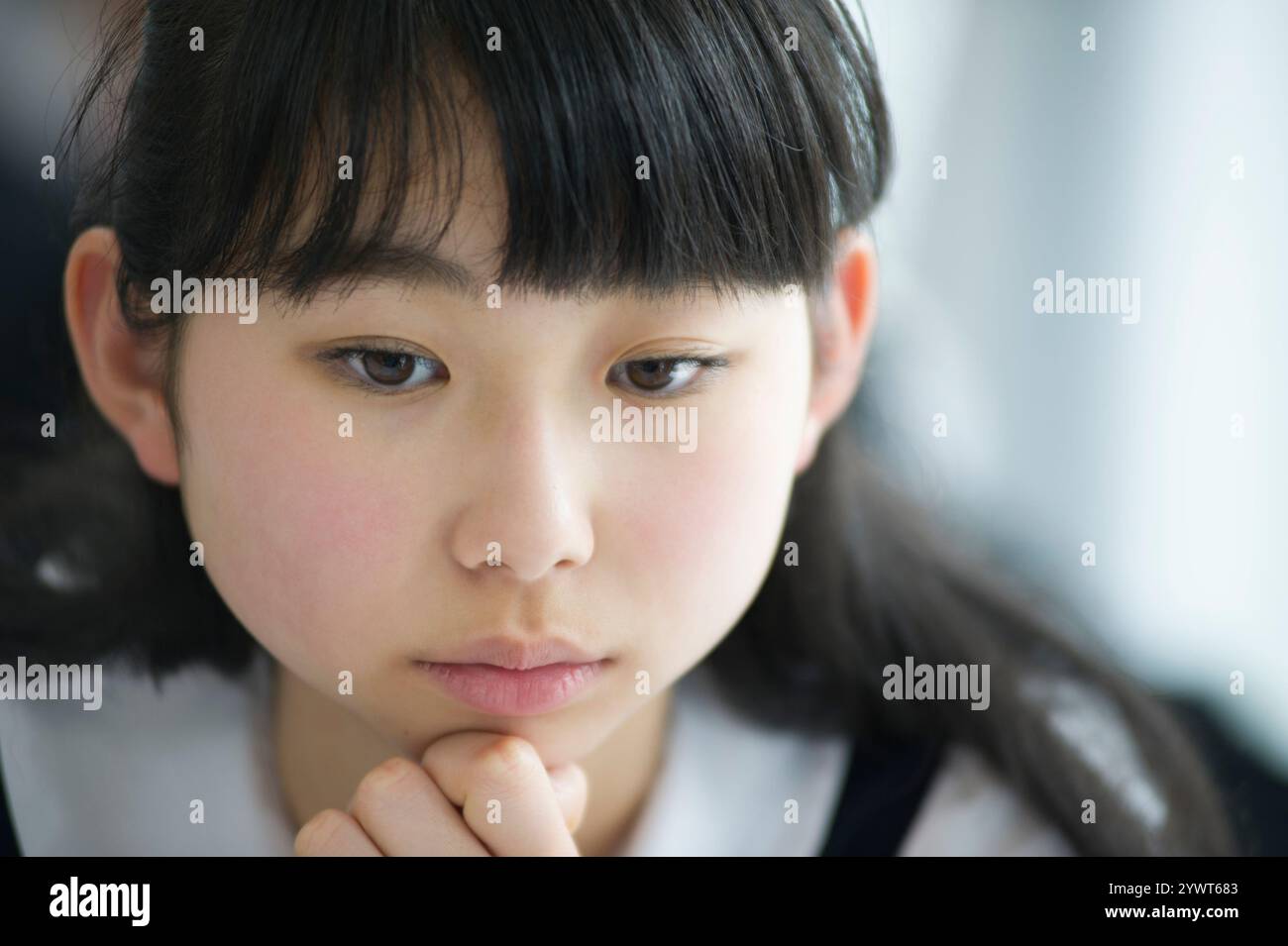 Female student thinking in the classroom Stock Photo - Alamy