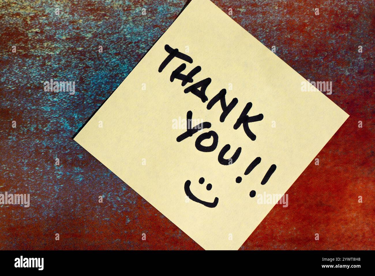 Thank you words written on a post-it or note. Stock Photo