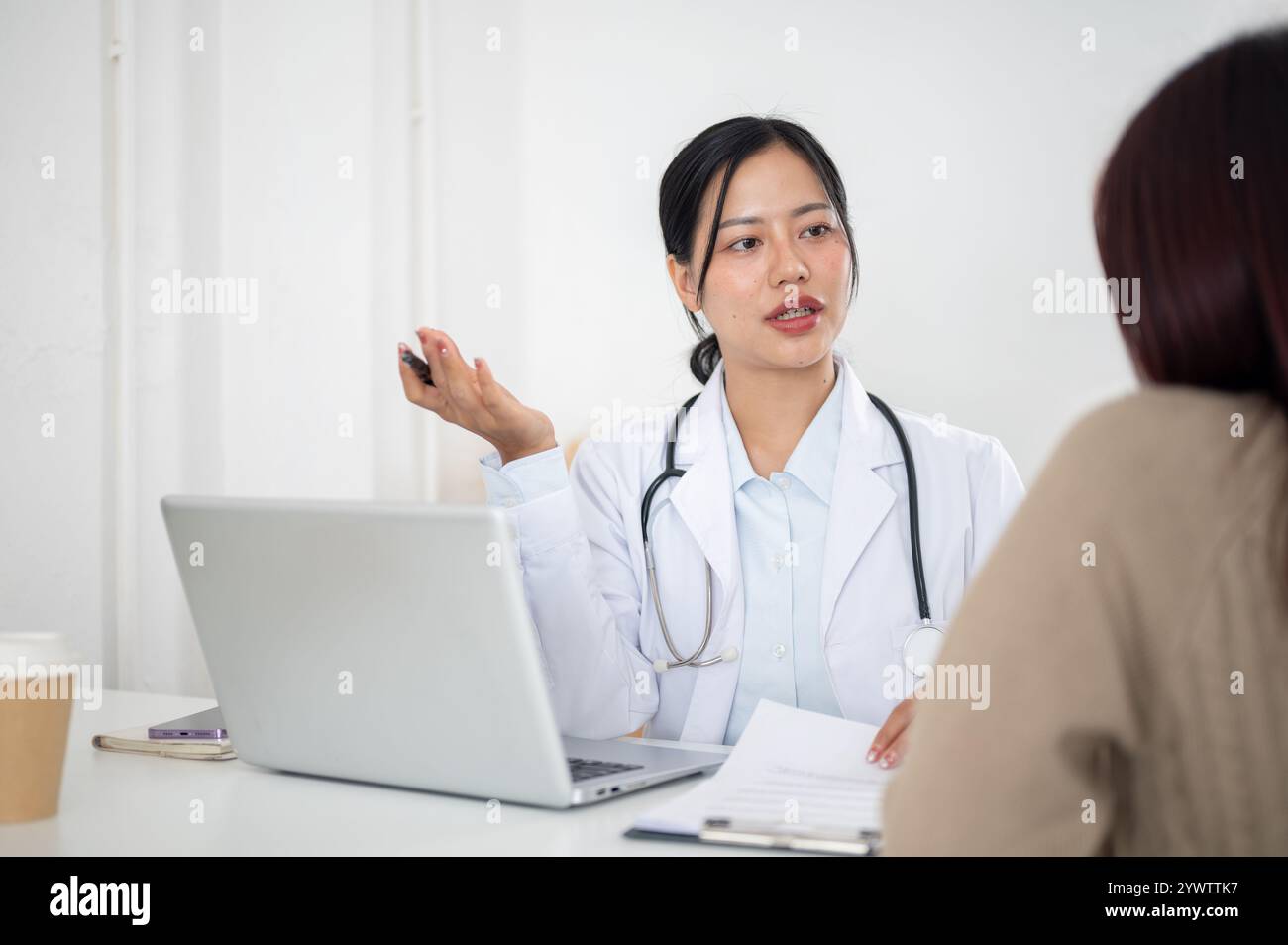Young asian female doctor speaking hi-res stock photography and images ...