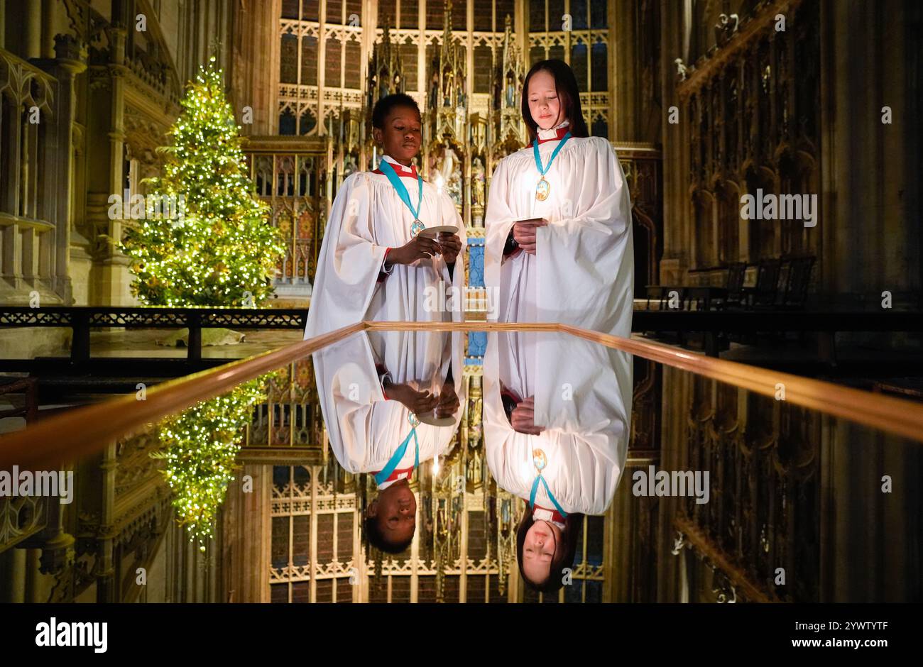 Gloucester Cathedral's Head Choristers Joel (left) and Ella hold candles ahead of rehearsals for the Cathedrals upcoming Advent Carol Services. Picture date: Wednesday December 11, 2024. Stock Photo