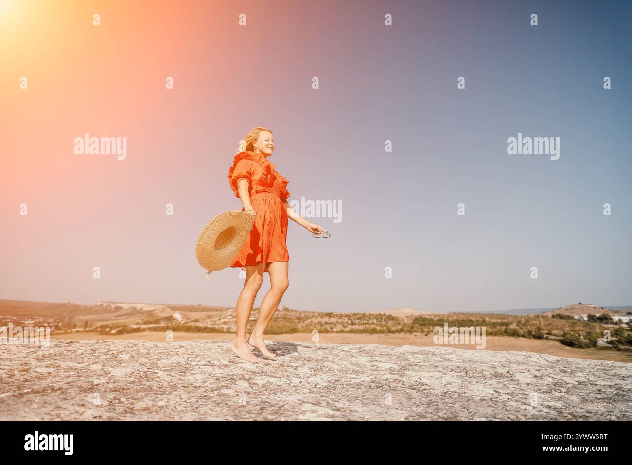Woman in Red Dress Walking on a Clifftop Stock Photo - Alamy