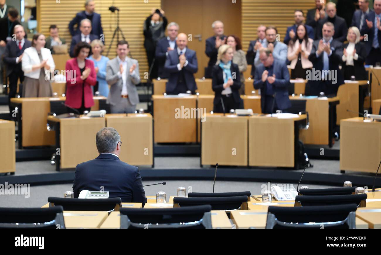 Erfurt, Germany. 12th Dec, 2024. Mario Voigt (front, CDU) is congratulated on his election in the Thuringian state parliament. CDU politician Voigt has been elected as the new Minister President and leads Germany's first blackberry coalition. Credit: Bodo Schackow/dpa/Alamy Live News Stock Photo