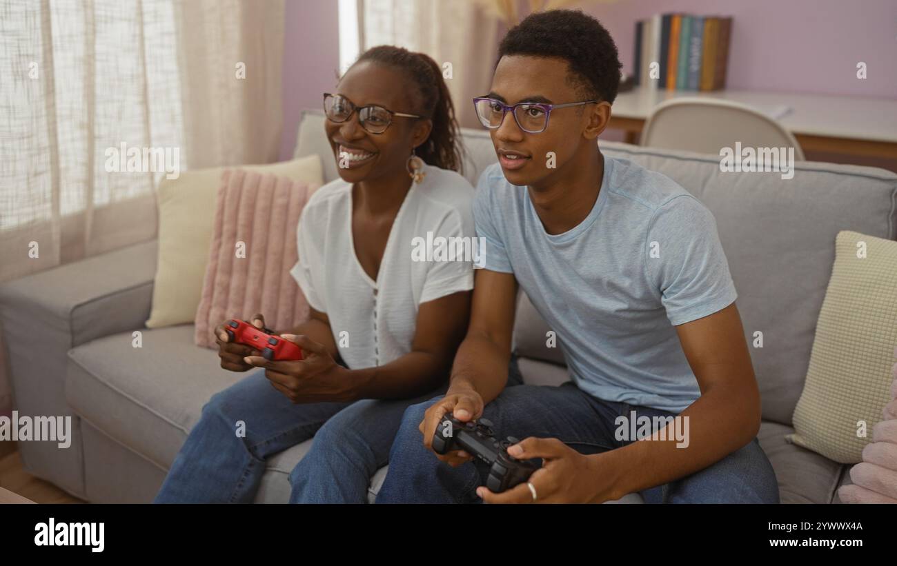 Mother and son playing video games together in a cozy living room ...