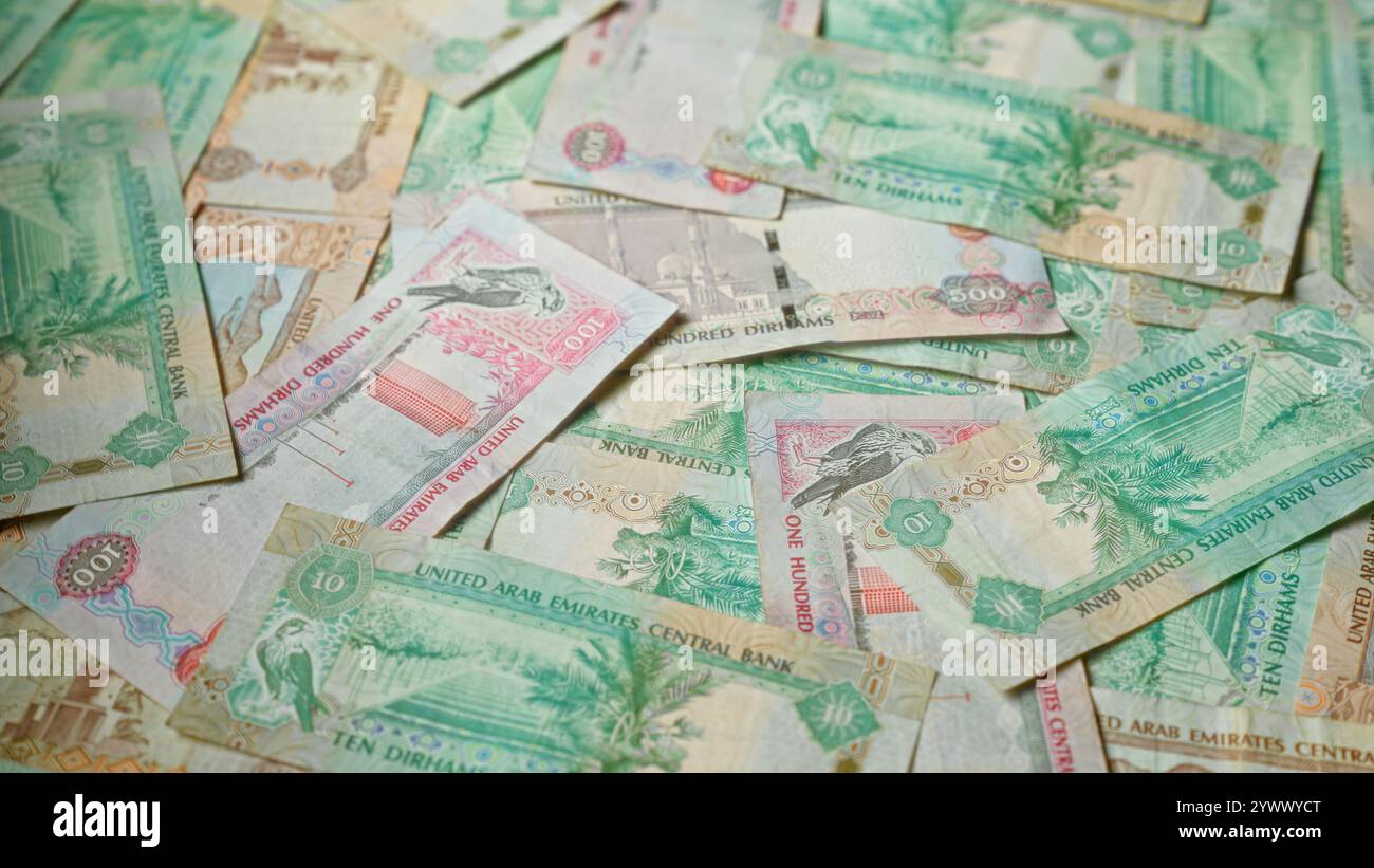 Uae Banknotes Scattered uae dirhams banknotes showcasing various denominations and ...