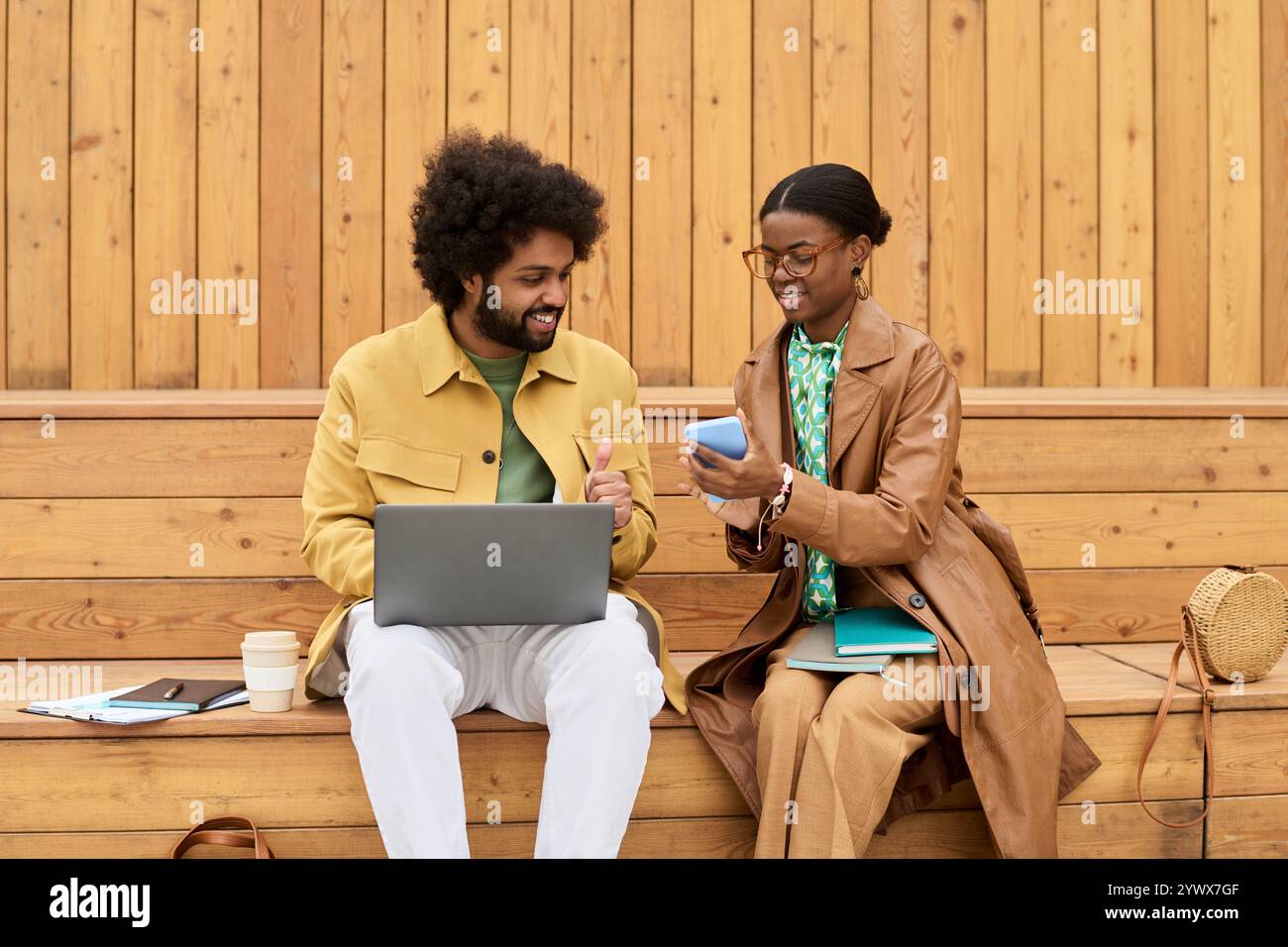 Collaborating and Sharing Ideas Outdoors on Wooden Bench Stock Photo
