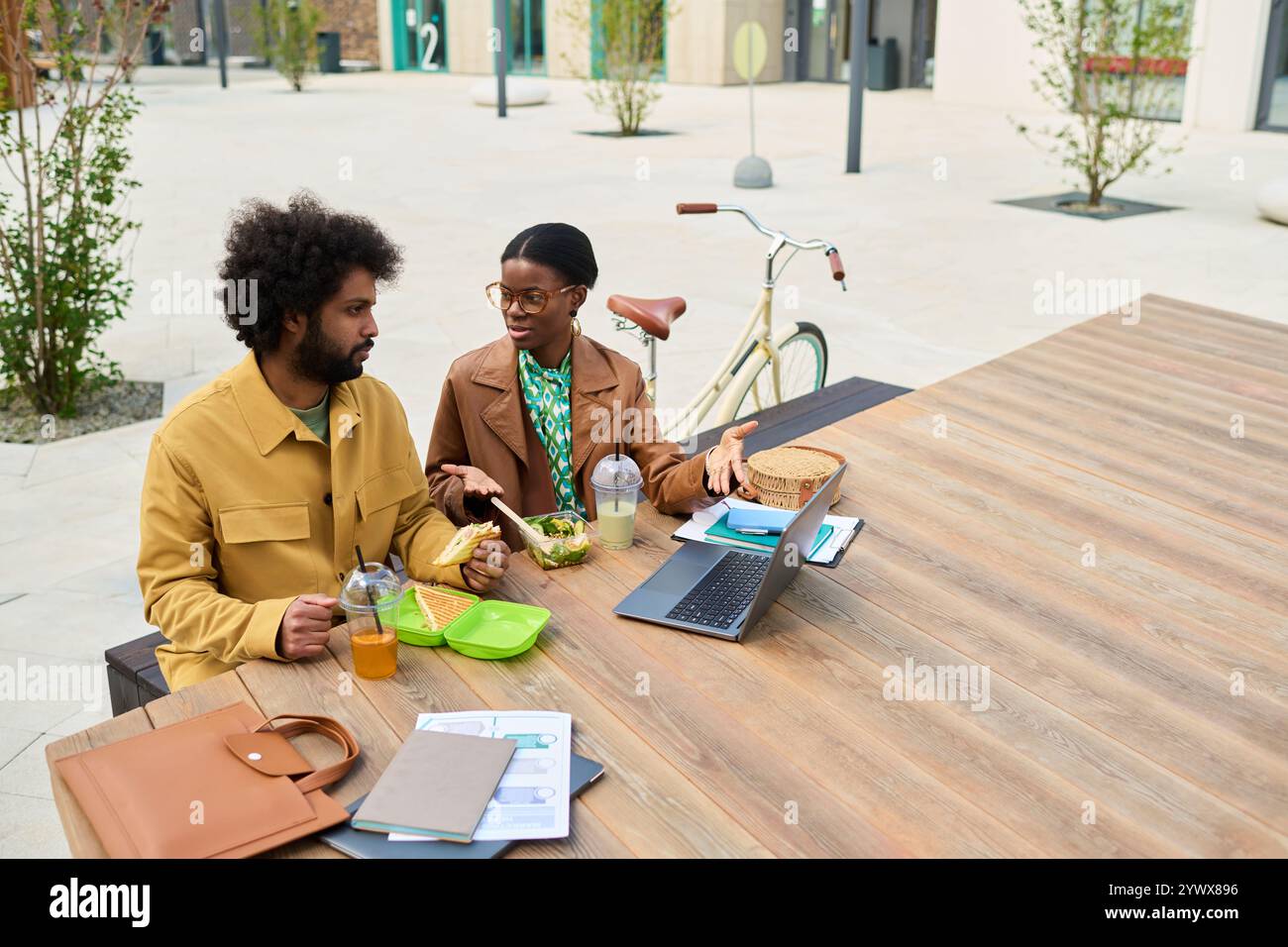 Discussing Work While Eating Lunch Outdoors Stock Photo