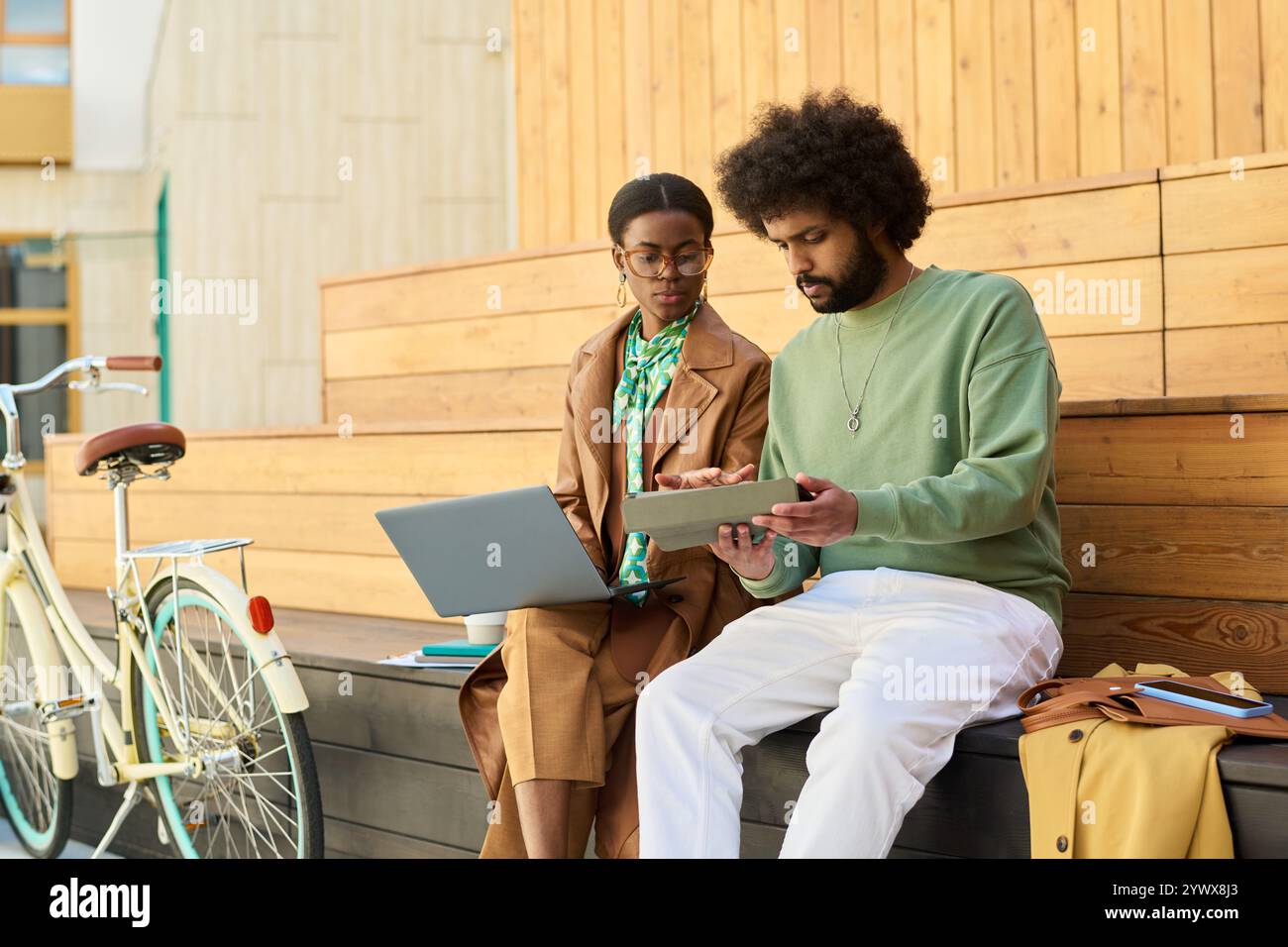 Collaborating on Outdoor Wooden Steps Using Gadgets Stock Photo