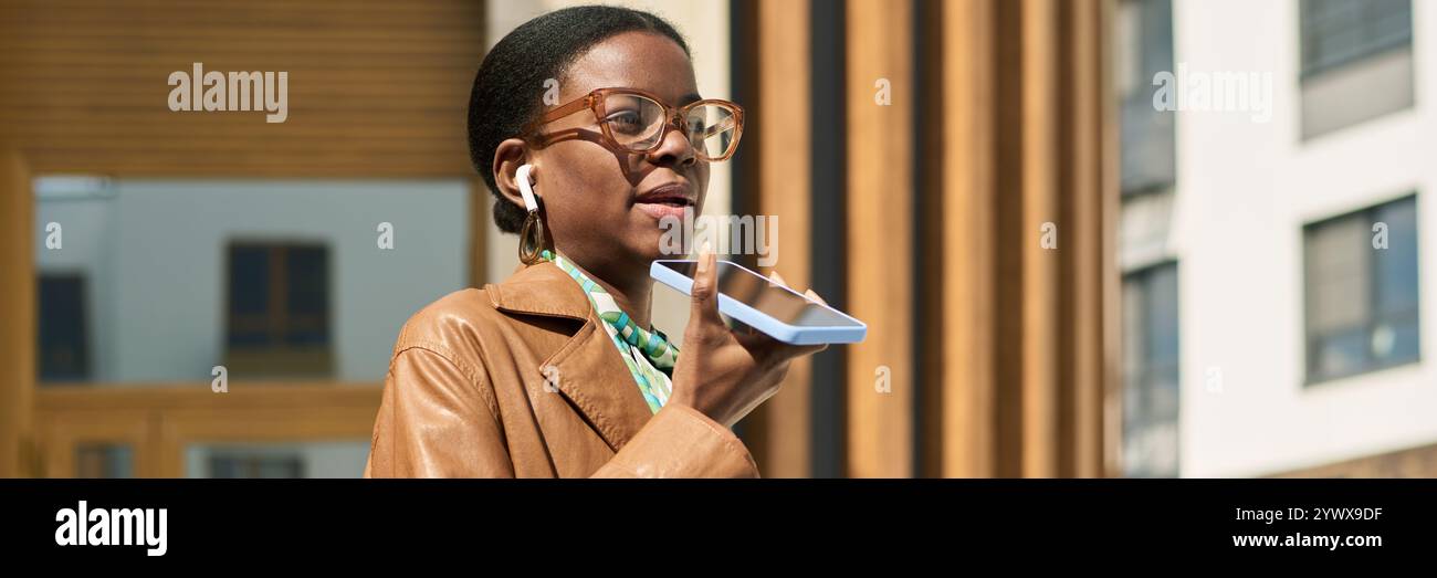 African American Woman Using Smartphone for Voice Message Stock Photo