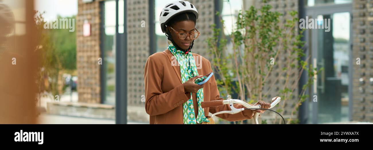 Young Woman Using Technology for Navigation While Riding Bike Stock Photo