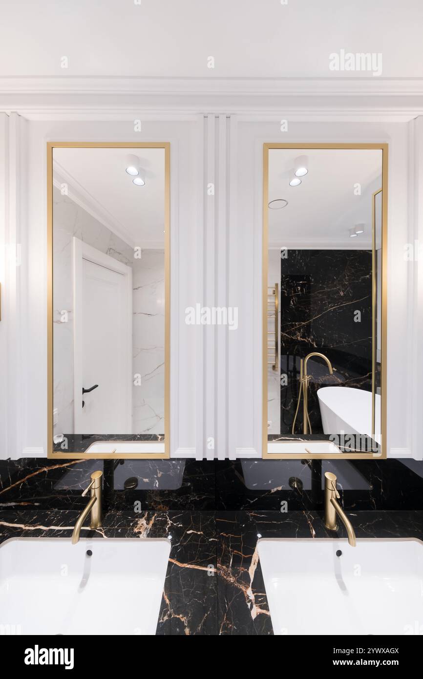 A bathroom with marble and stacked vertical subway tiles, a white oak ...