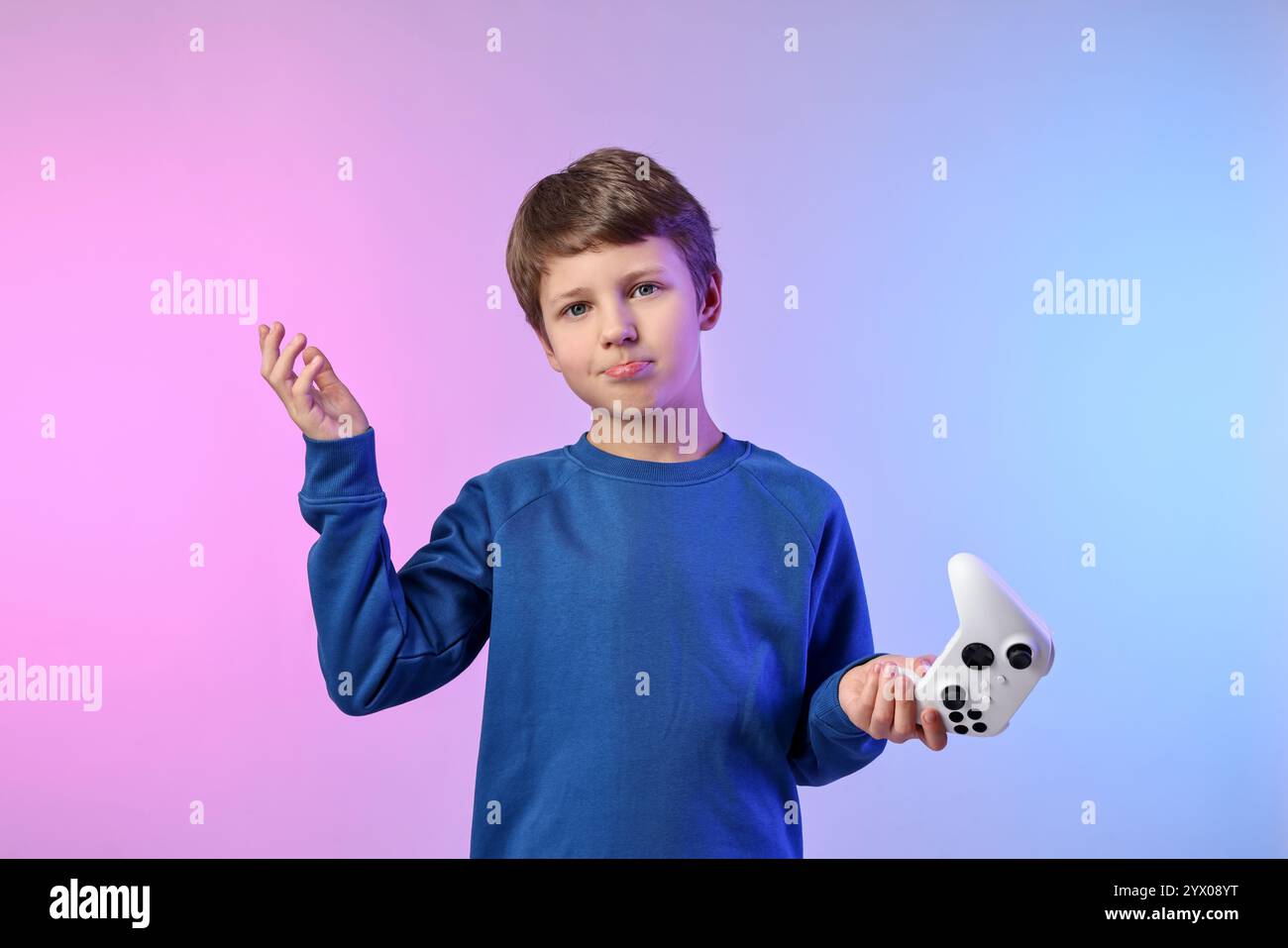 Cute little boy with controller on color background Stock Photo - Alamy