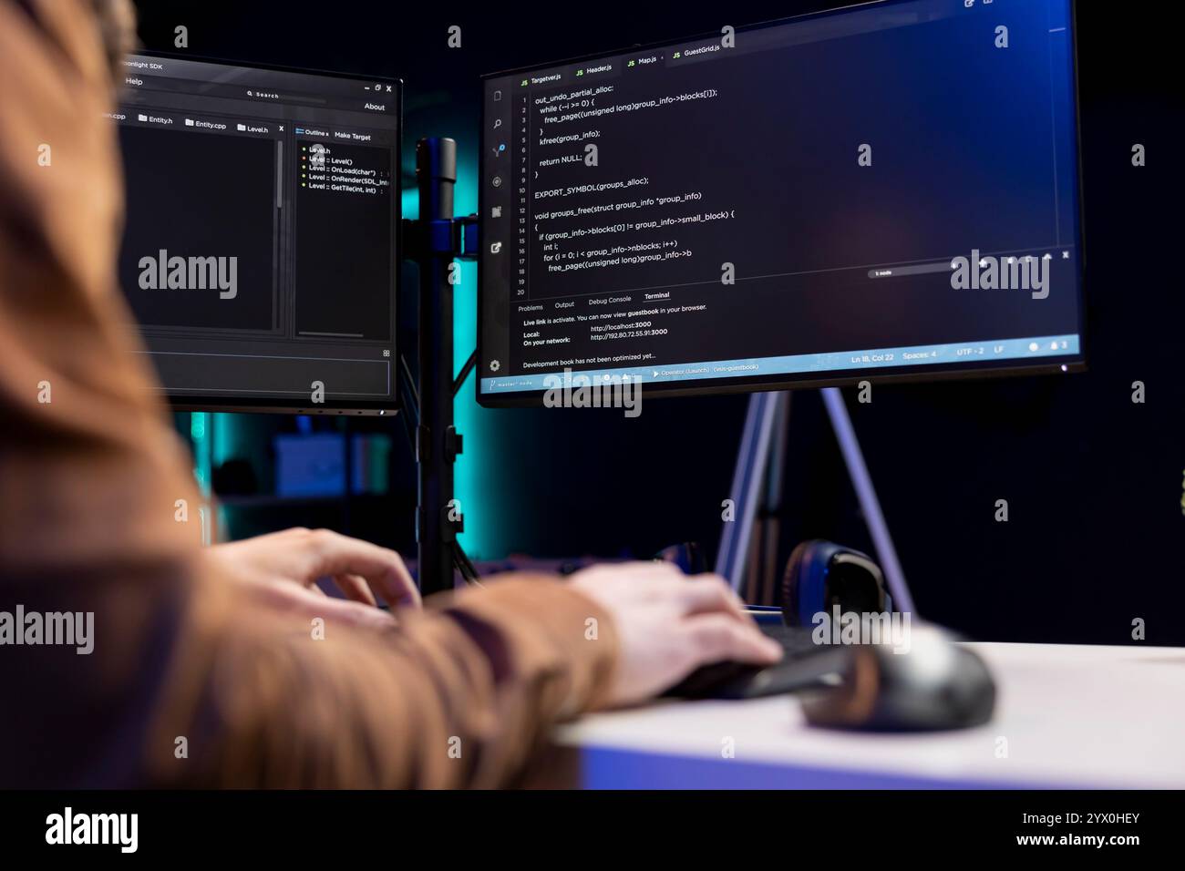 Teleworking cybersecurity administrator using computer to look for security vulnerabilities. IT technician typing on keyboard, installing safeguard code on PC to prevent cyber attacks, close up Stock Photo