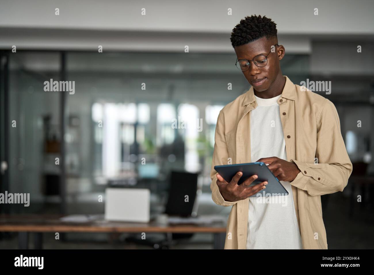 Busy young Black business man manager using tablet computer. Stock Photo