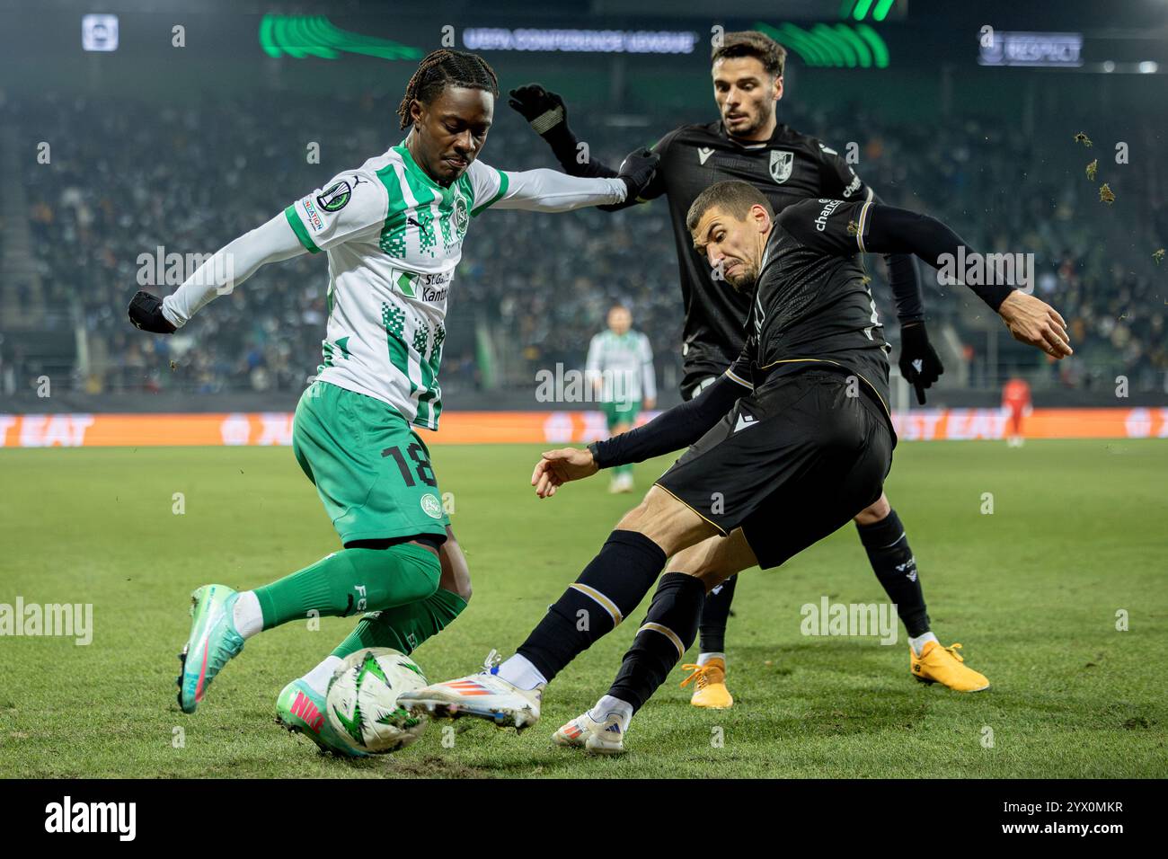 St. Gallen, Switzerland. 12th Dec, 2024. St. Gallen, Switzerland, December 12st 2024: A duel between Felix Mambimbi (18 FCSG) and João Mendes (13 Guimarães) during the UEFA Conference League football match between FC St. Gallen and Vitória SC at Kybunpark in St. Gallen, Switzerland. Philipp Kresnik (Philipp Kresnik/SPP) Credit: SPP Sport Press Photo. /Alamy Live News Stock Photo