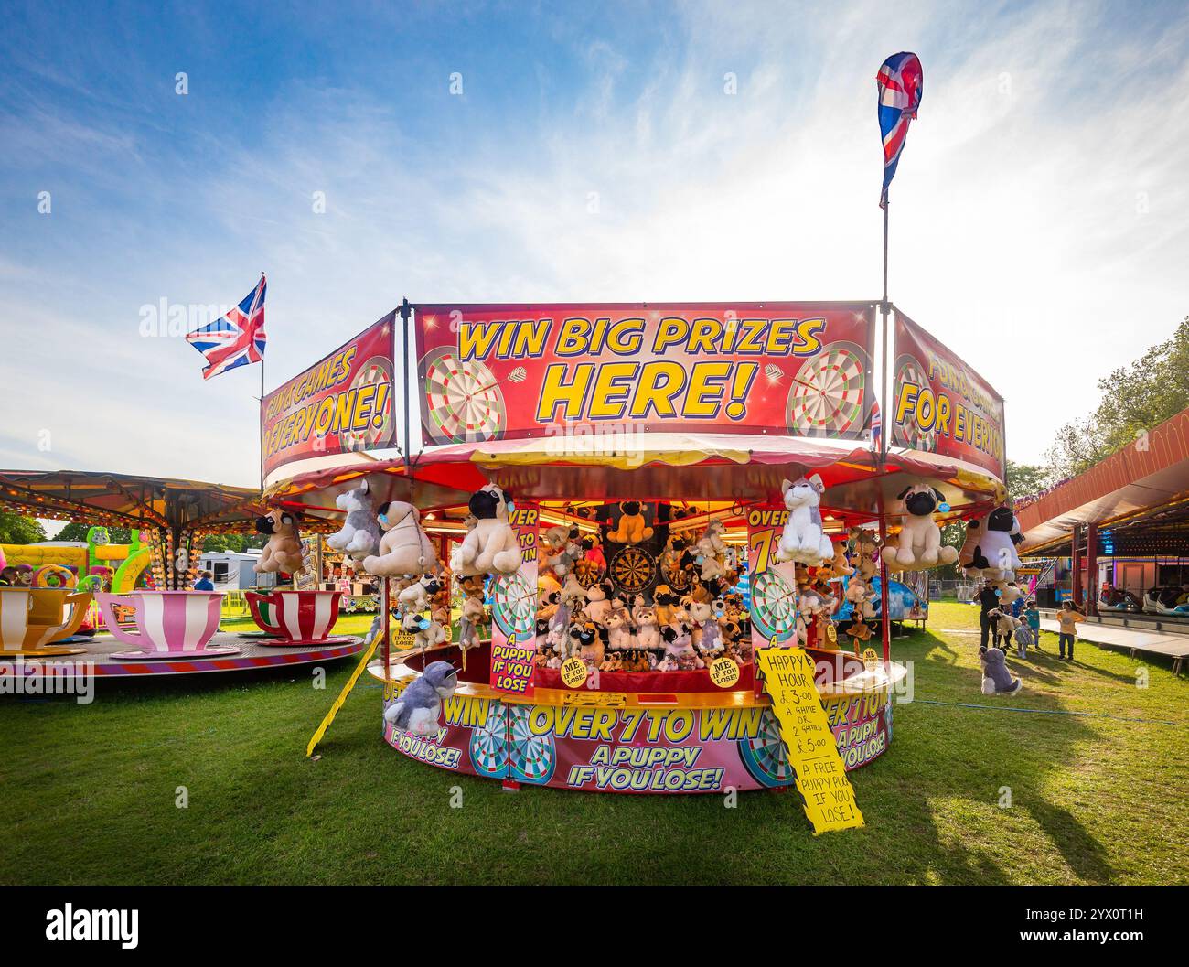 British fairground with colourful prize stalls, fun rides and british ...