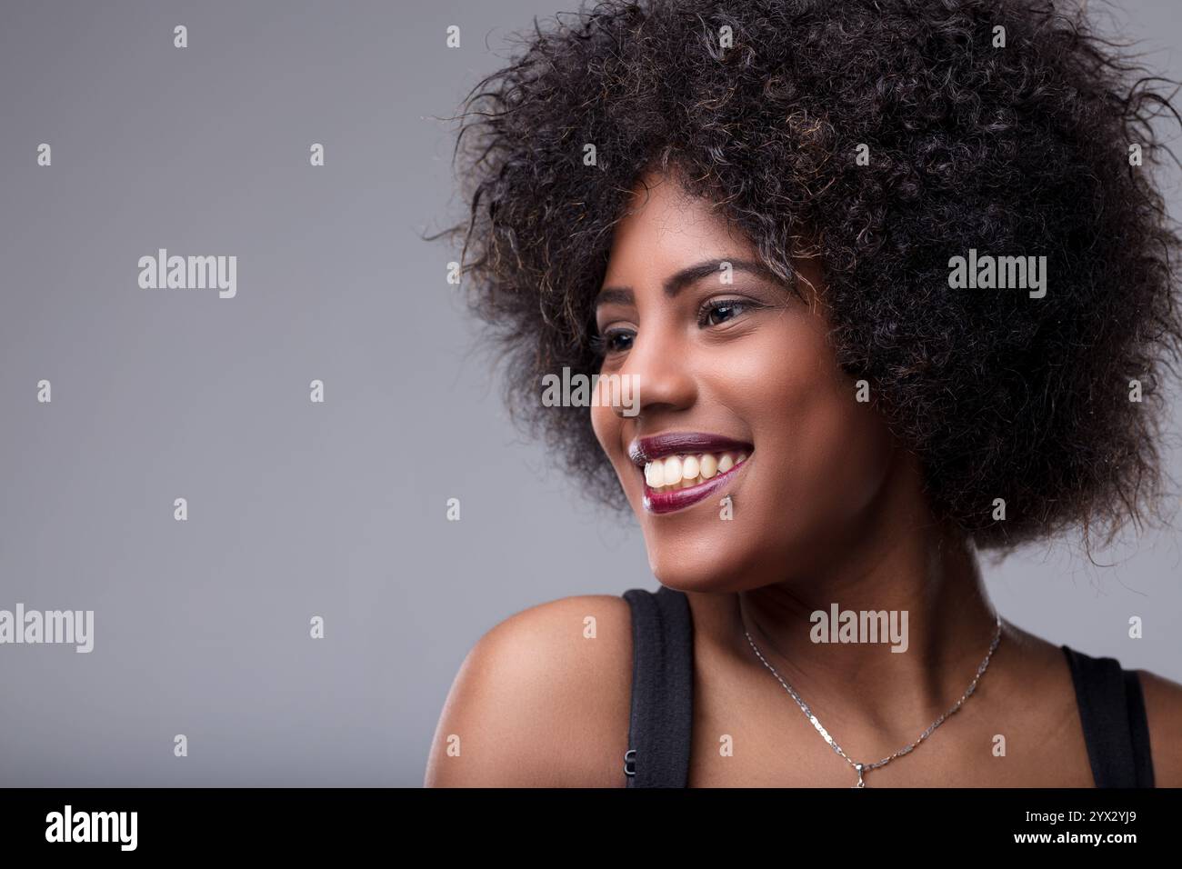 Studio portrait of a beautiful young black woman with curly hair ...