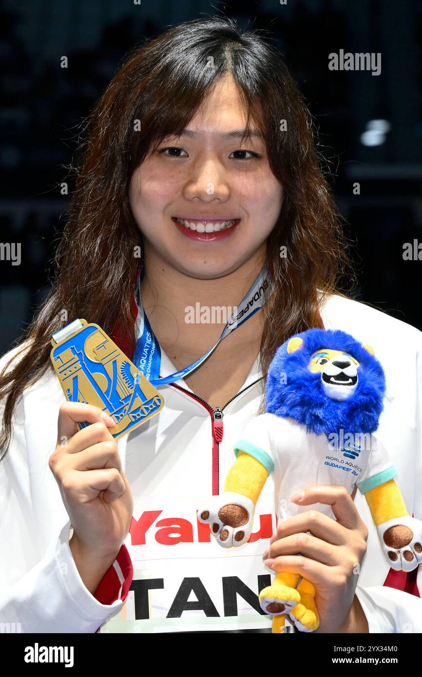 Qianting Tang of China shows her gold medal after competing in the 100m