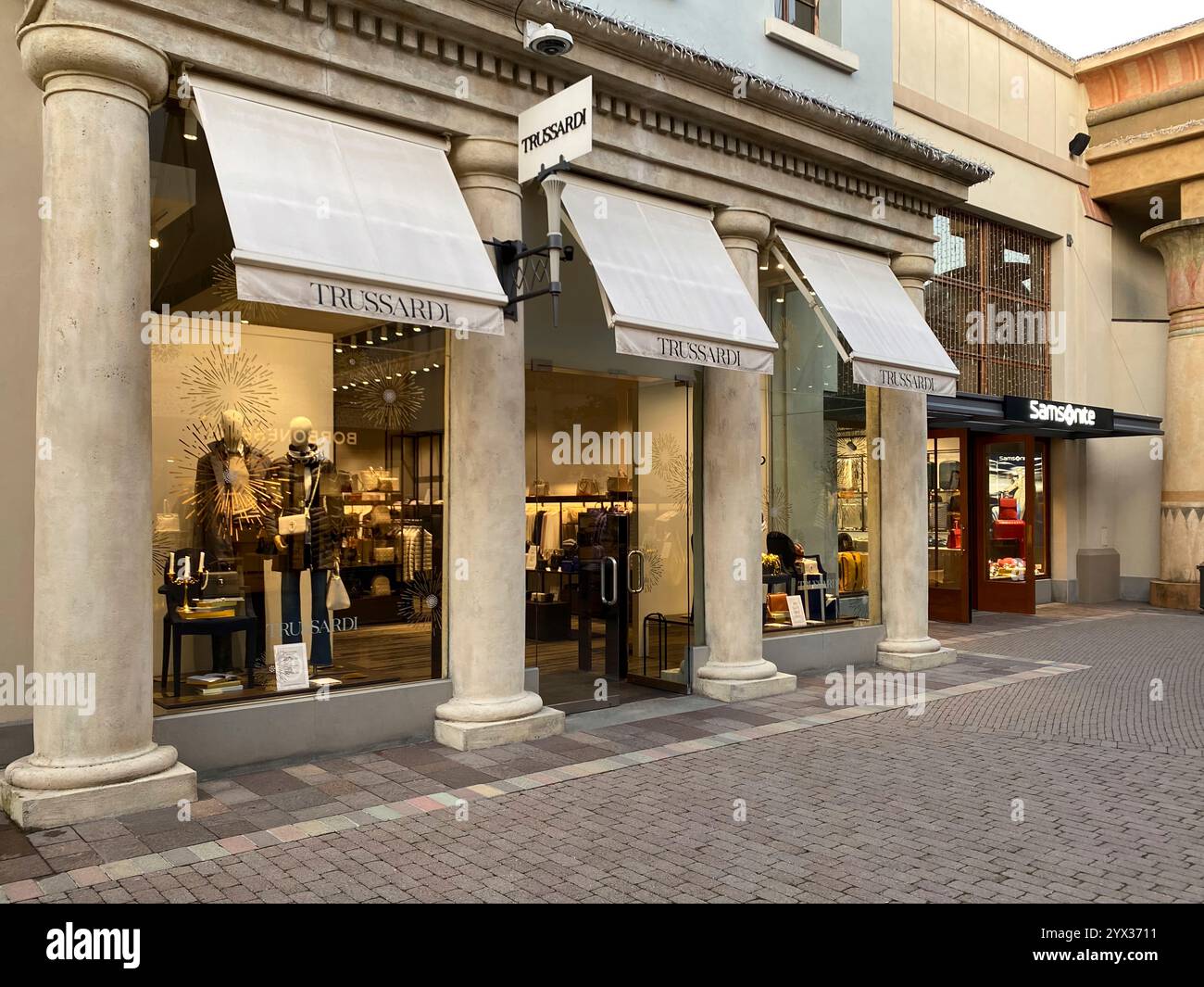Fidenza, PR, Italy - November 27th 2024 Italian shopping outlet fidenza village displaying luxury fashion brands trussardi and samsonite during winter Stock Photo