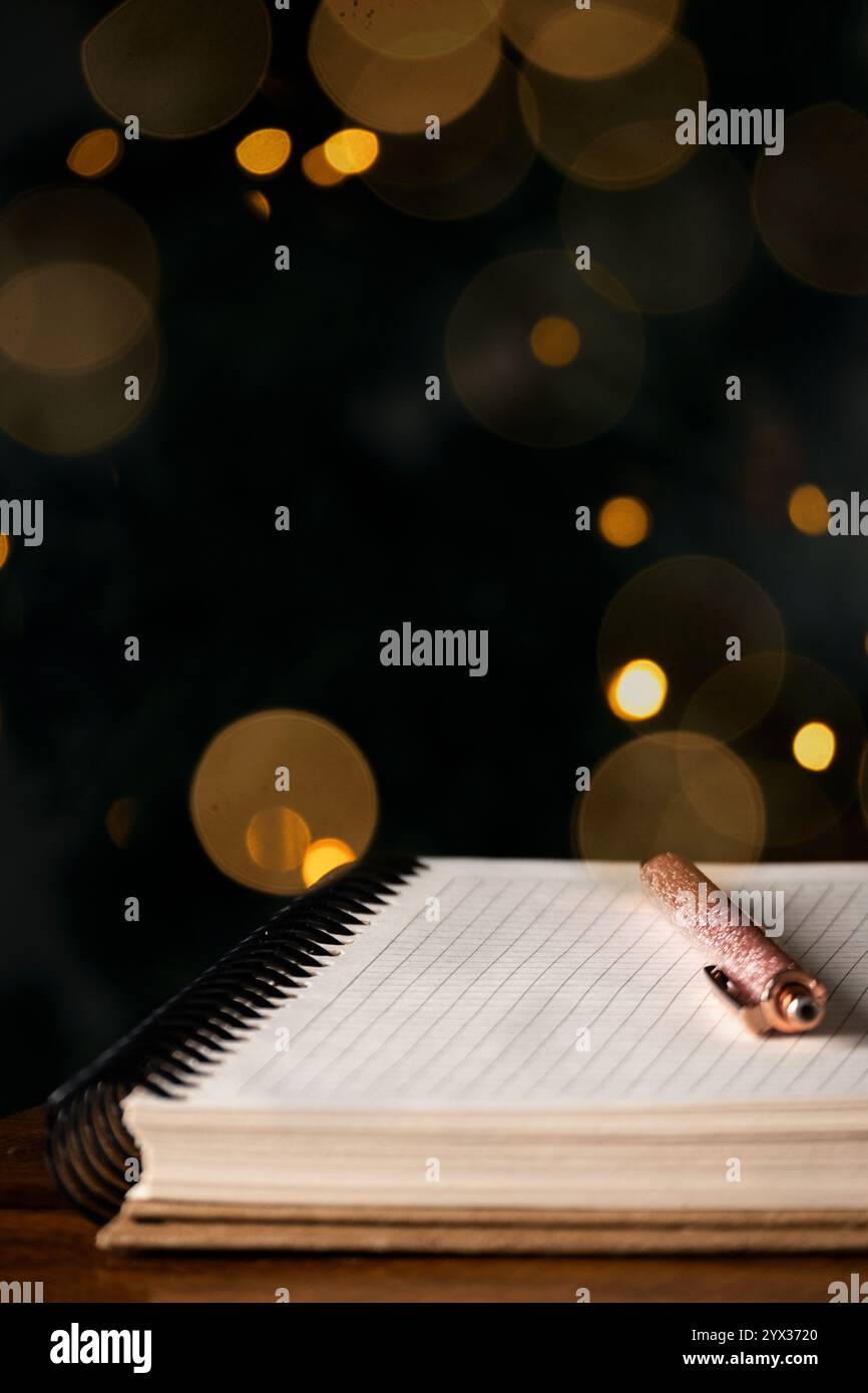 Empty block notes and a pen against magical light bokeh background Stock Photo