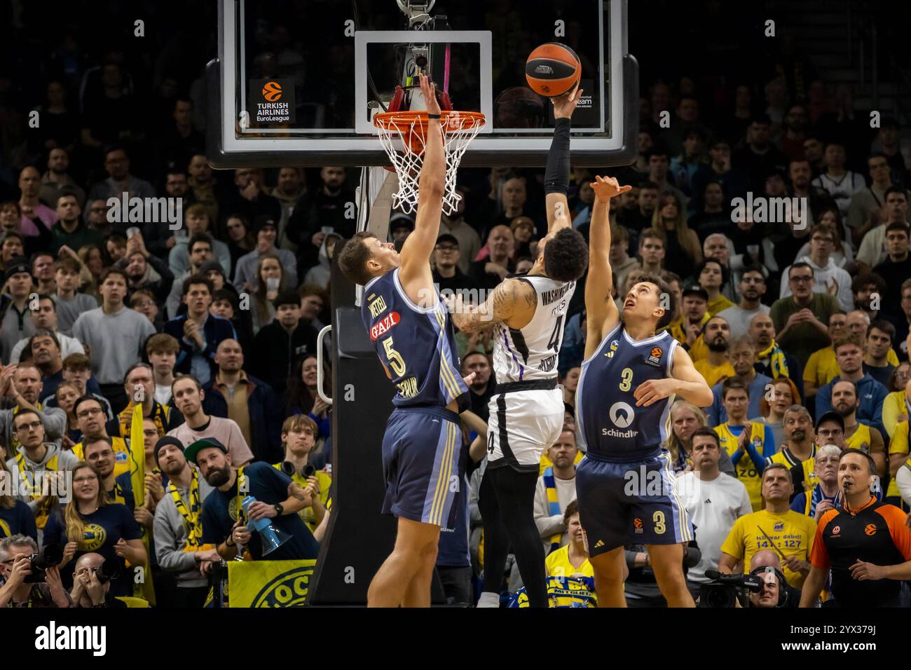 Berlin, Germany. 12th Dec, 2024. Duane Washington (4) of Partizan Belgrade seen in between Yanni Wetzell (5) and Matteo Spagnolo (3) of ALBA Berlin during the Turkish Airlines EuroLeague basketball match between ALBA Berlin and Partizan Mozzart Bet Belgrade at the Uber Arena in Berlin. Credit: Gonzales Photo/Alamy Live News Stock Photo