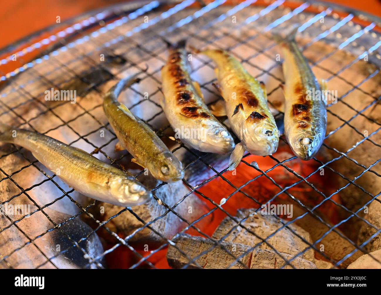 Gnathopogon caerulescens is cooked with burned charcoal at a local dish ...