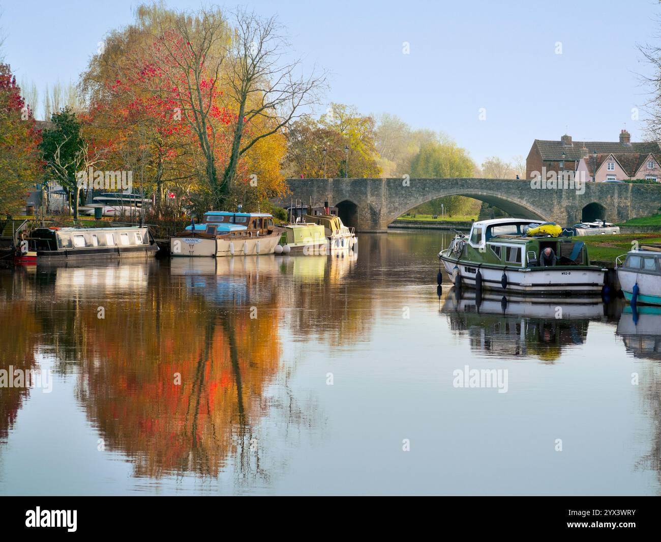 Houseboat s moored by the Thames at Abingdon. A fine view of the Thames at Abingdon, early on a clear morning, with the trees aflame with Autumn colou Stock Photo