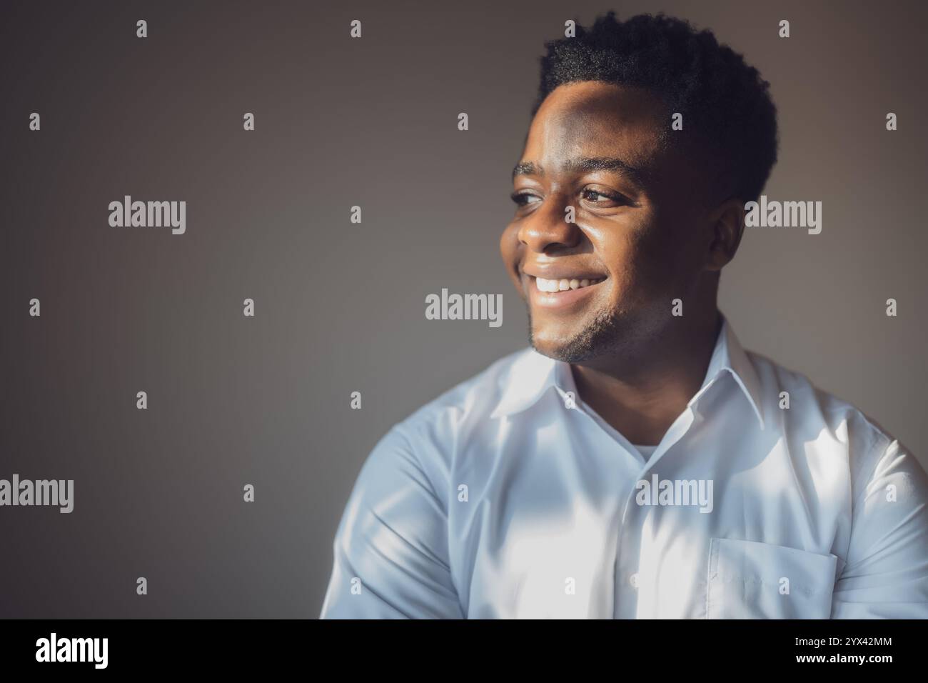 Portrait of happy man who is smiling and looking away. Stock Photo