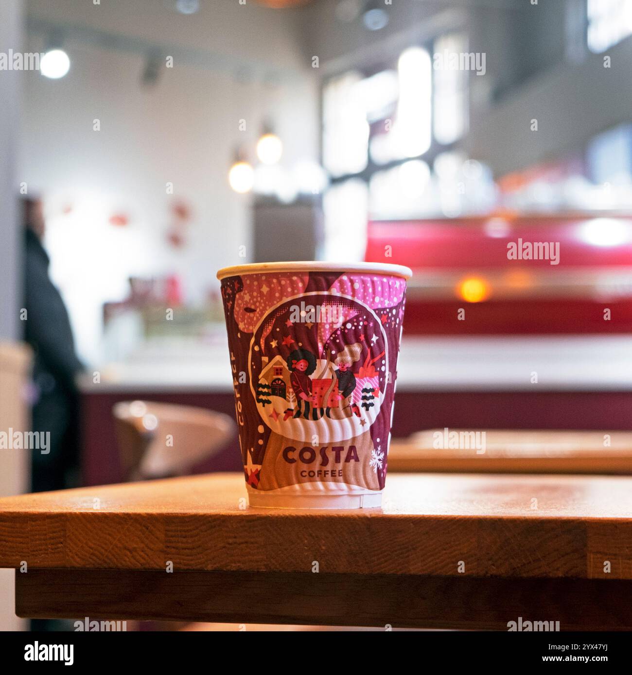 Costa coffee paper cup on table at Christmas Xmas inside Costa shop ...