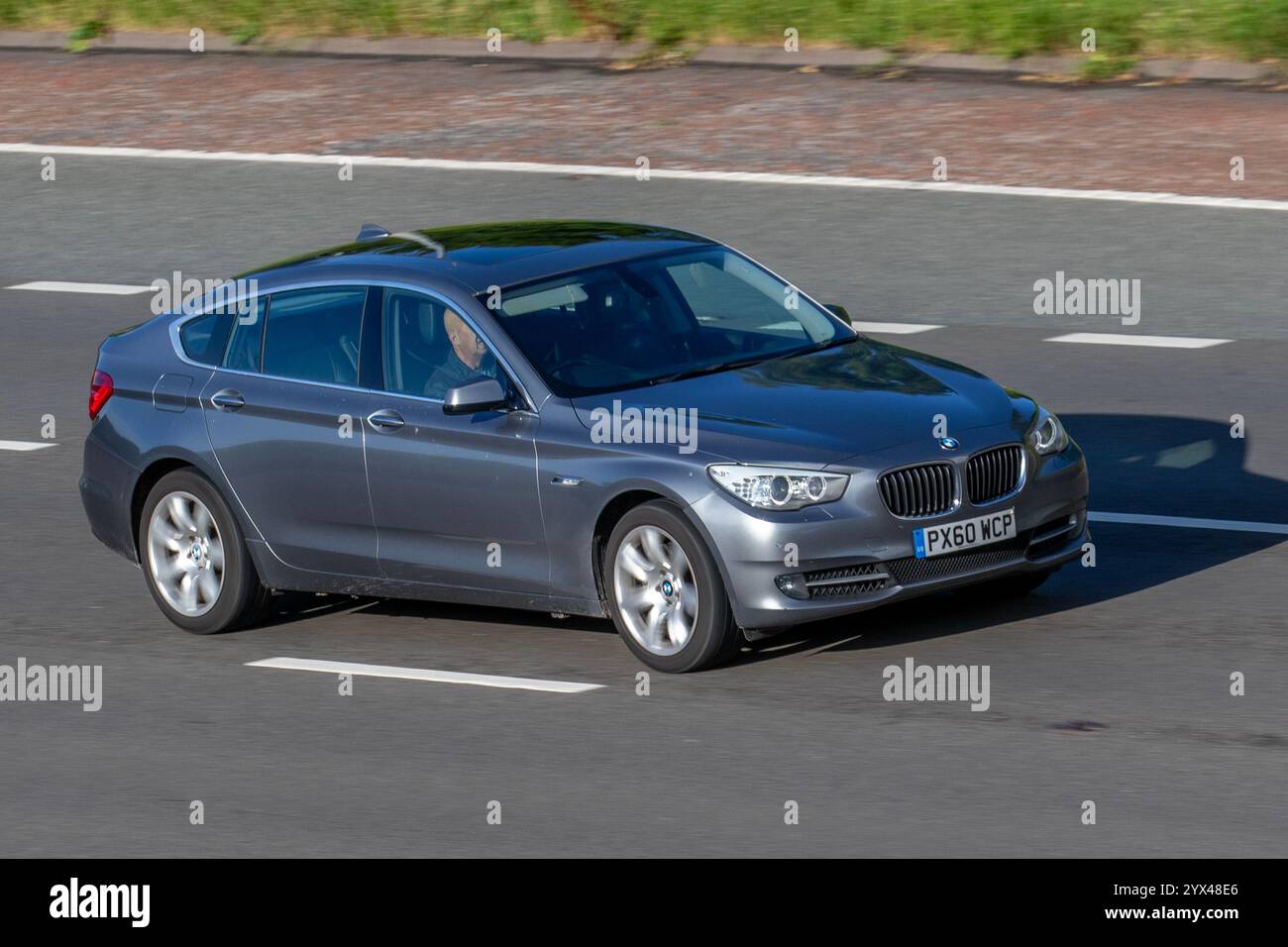2010 BMW 520D Se Auto 520D Step Auto Opt Start/Stop Grey Car Saloon Diesel 2000 cc; travelling on the M61 motorway, UK Stock Photo