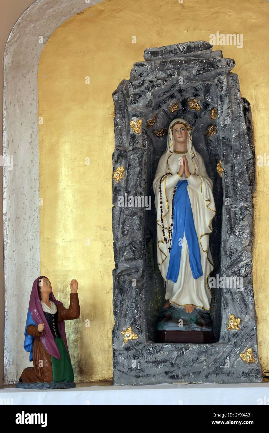 Grotto of Our Lady of Lourdes in parish church Name of Mary in Svilaj, Croatia Stock Photo