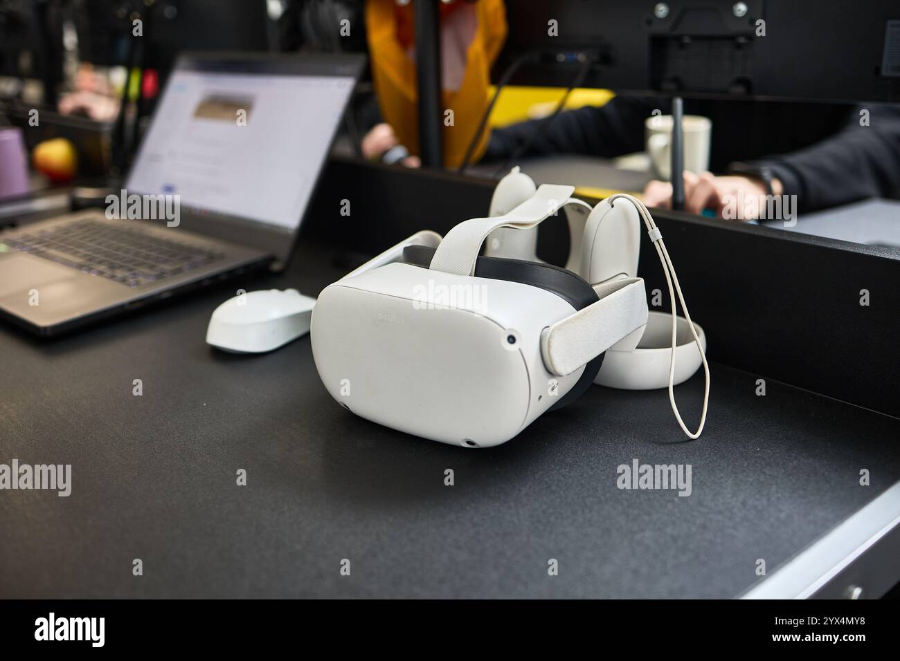 On modern office desk, a virtual reality headset and laptop, technology ...
