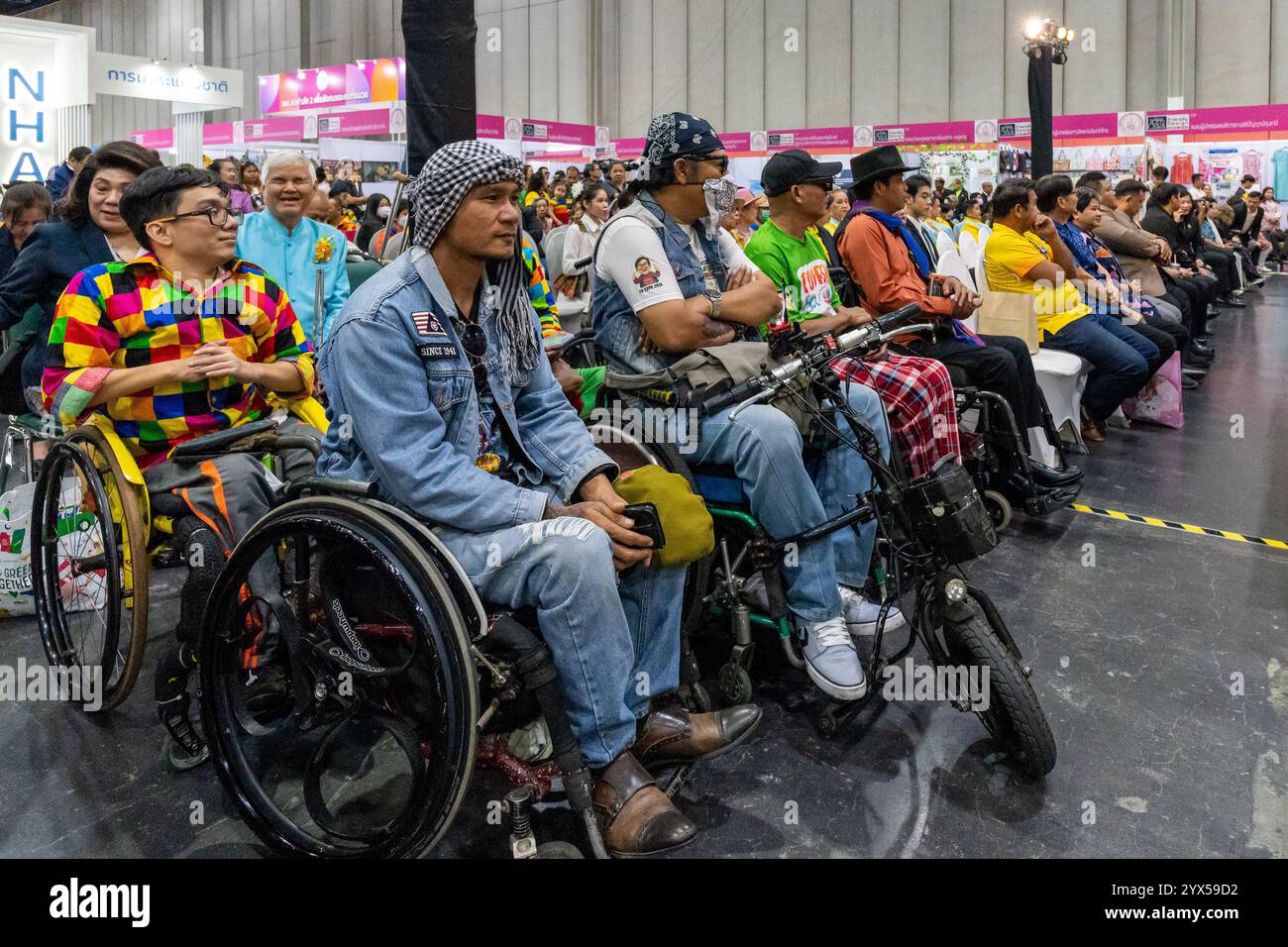 People with disabilities, in wheelchairs, attend the opening ceremony of the Thailand Friendly Design Expo 2024, at The Bangkok International Trade and Exhibition (BITEC). The Thailand Friendly Design Expo 2024 aims to create a more inclusive and sustainable society for the elderly and people with disabilities in Thailand through design and technology. Founded by Krisana Lalai, a Thai journalist and human rights activist, the event promotes accessibility across various sectors. After a car accident in 1997 left him paralyzed, Krisana dedicated his life to advocating for inclusive design and eq Stock Photo