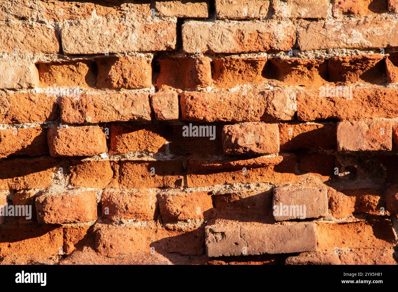 Old red brick wall texture background closeup Stock Photo